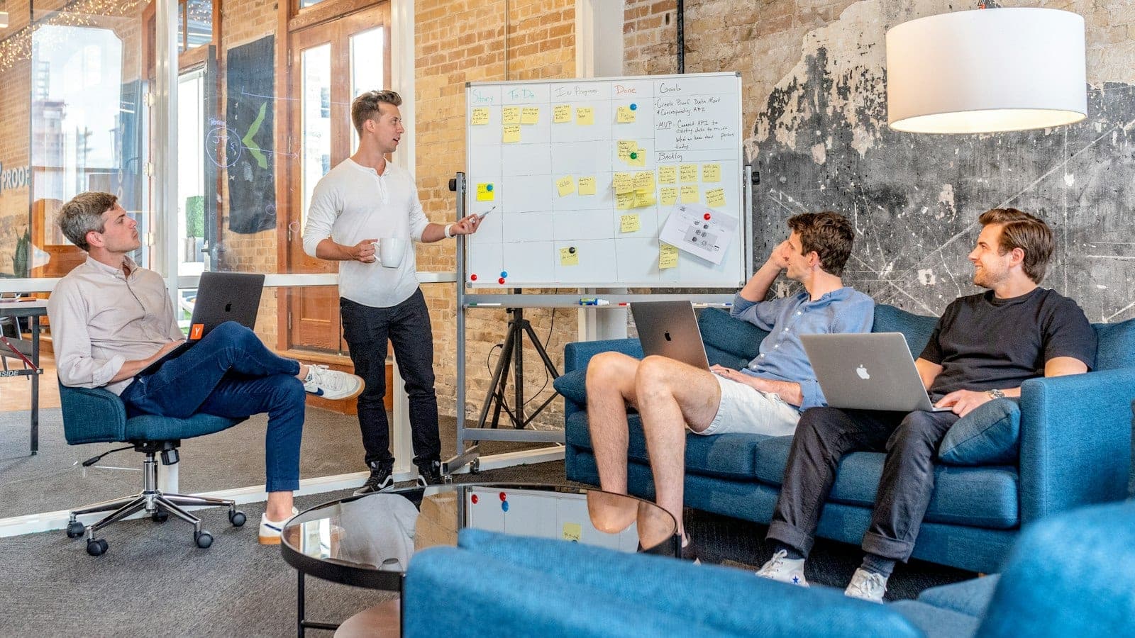 A founder and a sales leader at a whiteboard covered in a hand-drawn pipeline chart with gaps, coffee cups on the table, early morning light through an office window.